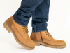 Ara 11-23654-19 Frederik - Cognac laced boot worn with dark blue jeans on a white background. 