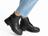 Ara 12-59114-01 Manchester - Black leather laced ankle boots with buckle detail worn by a lady wearing light blue jeans on a white background.