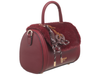 Bessie London Plush Barrel handbag in burgundy with faux fur trim and decorative pretzel charm on a white background
