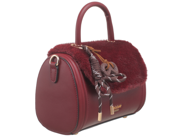 Bessie London Plush Barrel handbag in burgundy with faux fur trim and decorative pretzel charm on a white background