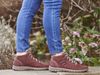 Josef Seibel Steffi 53 93153 410 - fur lined laced ankle boot in Bordeaux worn with skinny jeans against a background of plants. 