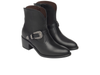 Pair of NeroGiardini I513900D 100 - Black western inspired ankle boots with a silver buckle on a white background