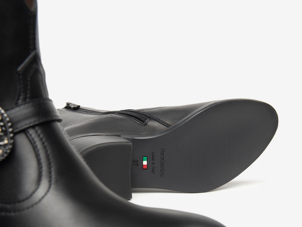 Close-up of NeroGiardini I513900D 100 - Black western inspired ankle boots with a  brand logo on a white background