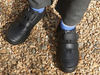 Startrite Rhino Warrior-8237-7 - Black school shoe with two Velcro straps worn by a boy on gravel surface